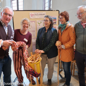 Ludger Mennes und Heidi Wolfsgruber halten den ersten Meter Teppich in der Hand, der mit einer Riesenstrickliesl gefertigt wurde. 